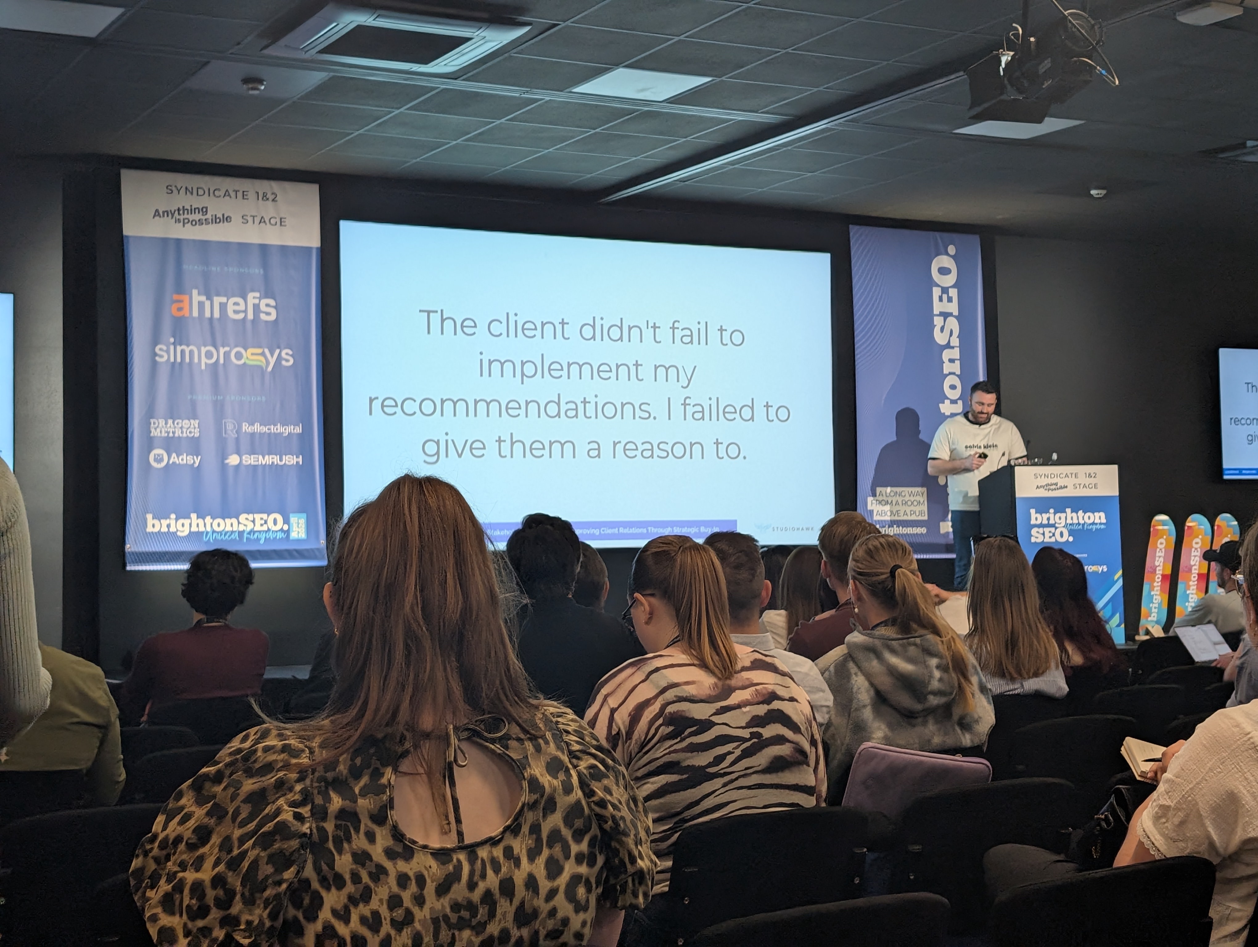 Jake Rudge's slide at brightonSEO April 2026 with the key message that the client did not fail — the SEO failed to give them a compelling enough reason to act
